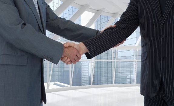 composite of business people shaking hands